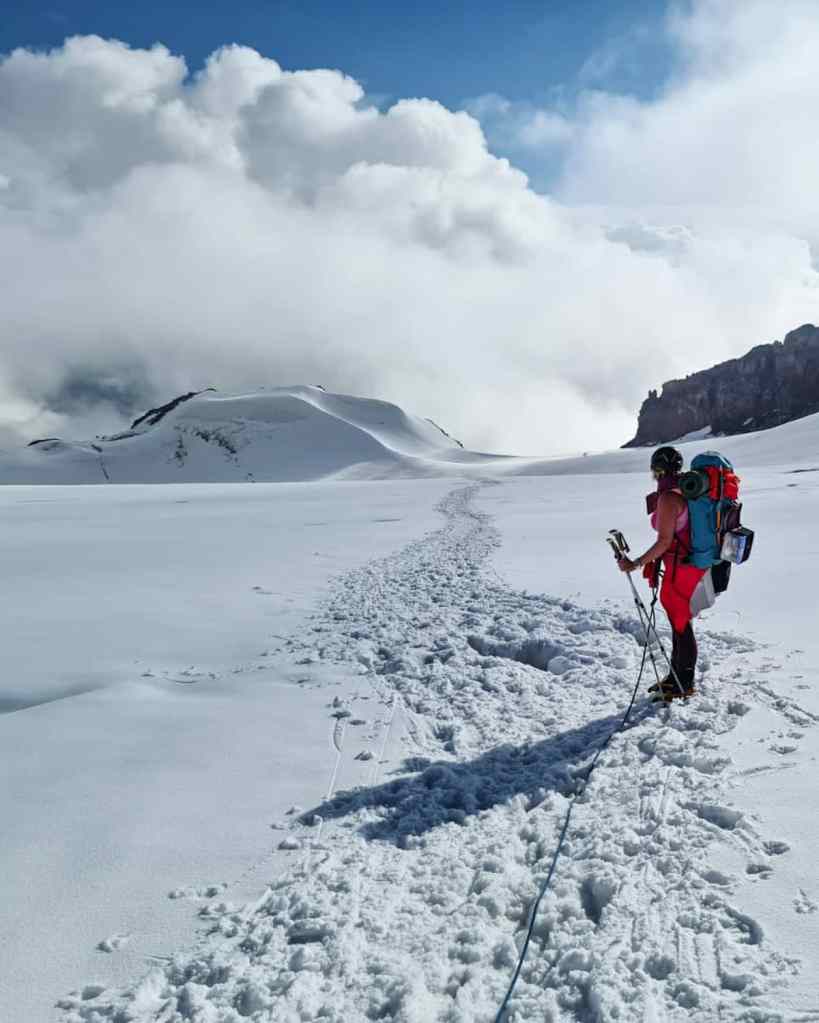Inga Ecker looking at a crevasse on Kazbek Glacier.