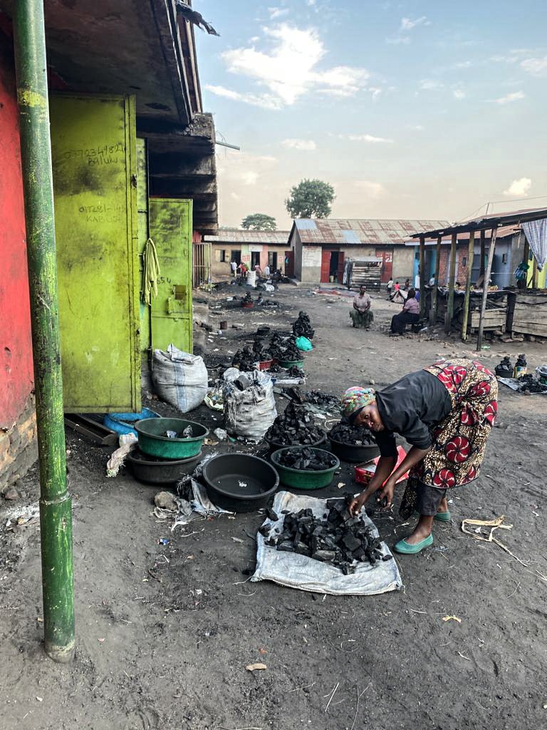 Woman selling charcoal at the market of kasese, Uganda.